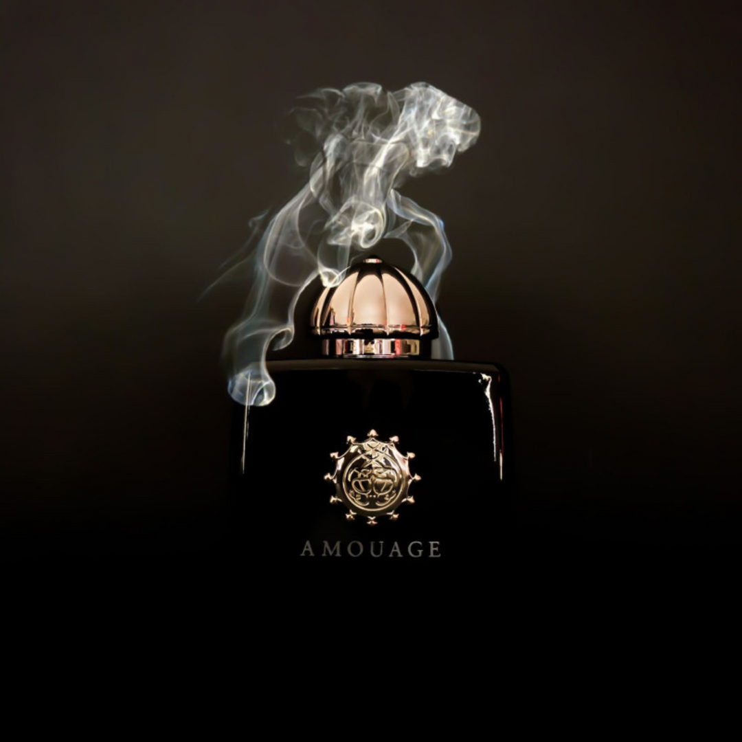 Amouage Memoir Woman EDP 100ml perfume bottle straight front view on dark smoky background – intense mysterious spicy floral chypre scent with cardamom mandarin absinthe, clove pink pepper jasmine rose, musk oakmoss leather incense styrax