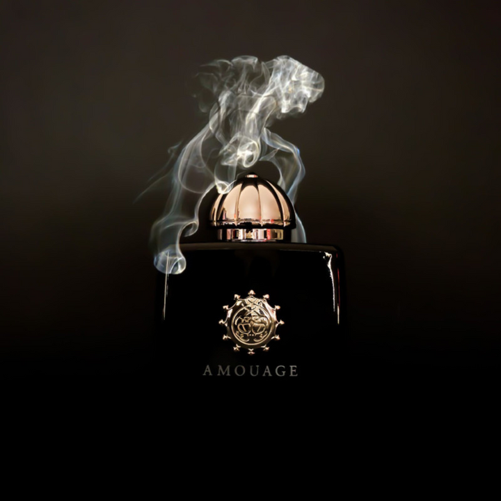 Amouage Memoir Woman EDP 100ml perfume bottle straight front view on dark smoky background – intense mysterious spicy floral chypre scent with cardamom mandarin absinthe, clove pink pepper jasmine rose, musk oakmoss leather incense styrax
