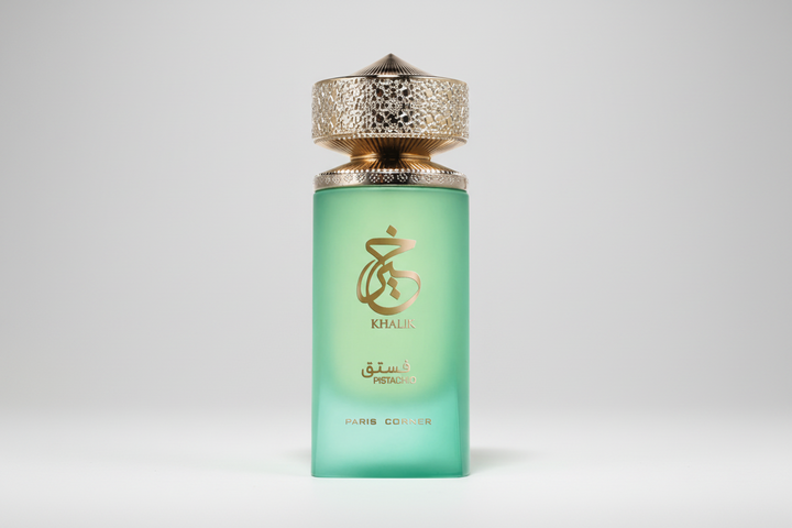 Green perfume bottle with gold cap on a light gray background