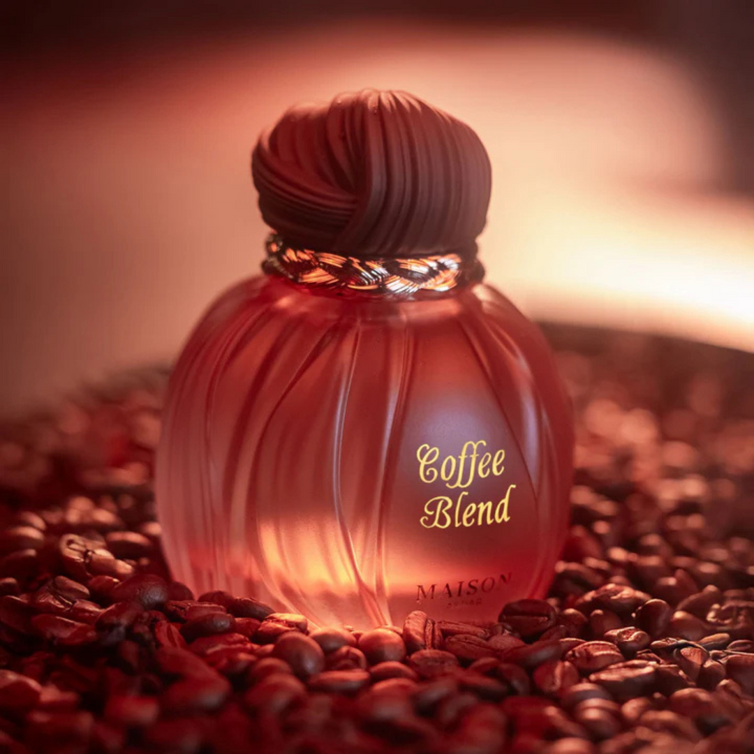 Maison Asrar Coffee Blend EDP 100ml perfume bottle straight front view sitting on roasted coffee beans – warm sweet coffee fragrance with coffee bergamot, caramel vanilla jasmine, amber tonka bean sandalwood musk
