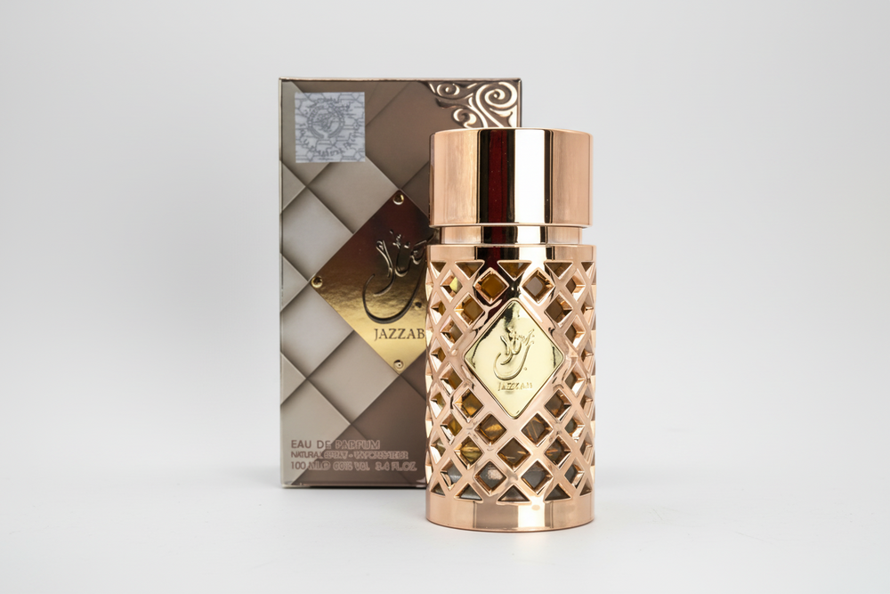Ard al zaafaran jazzab gold Rose gold perfume bottle with decorative packaging on a white background