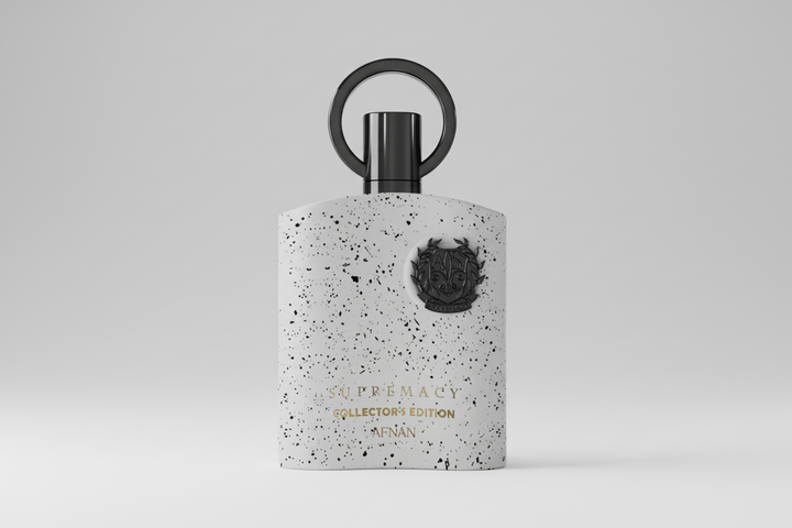 Perfume bottle with speckled design and black cap on a light gray background