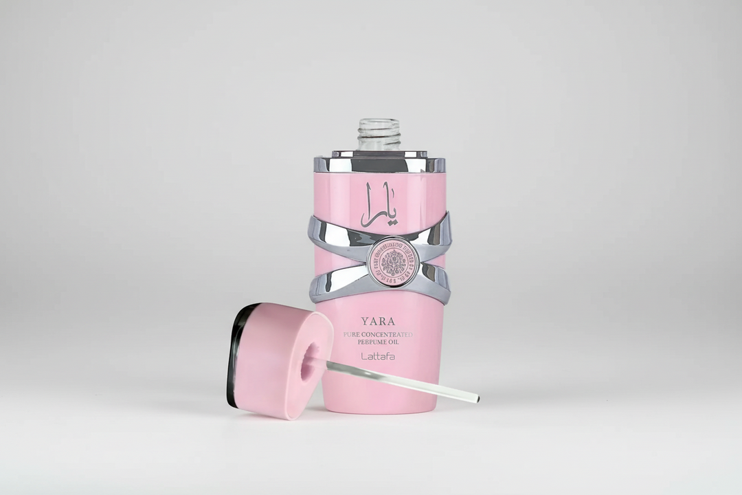 Pink and silver bottle with a cap on a light gray background