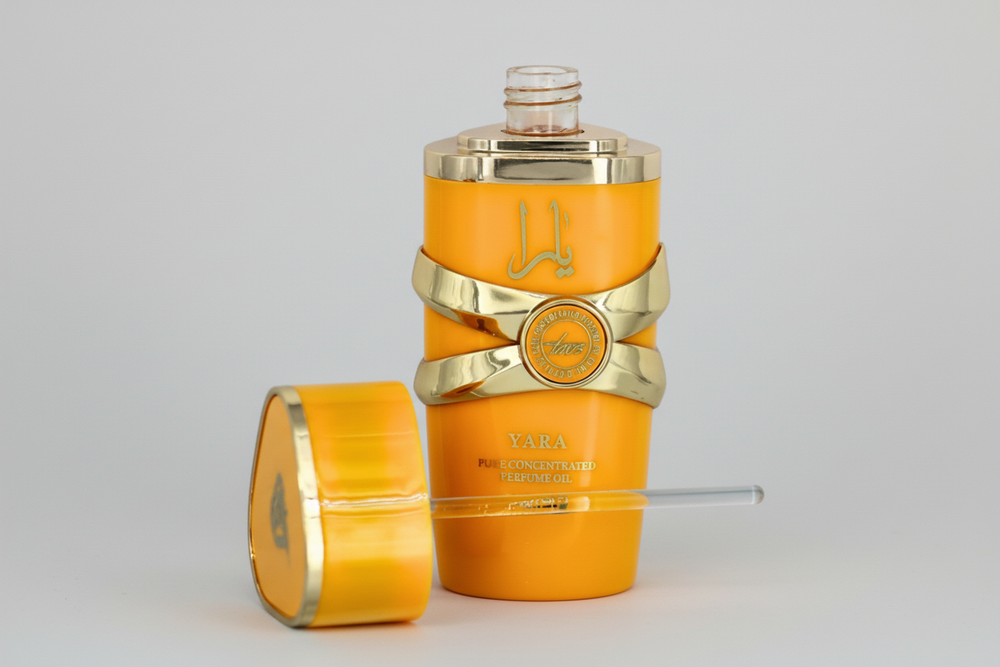 Orange and gold perfume bottle with decorative elements on a light gray background