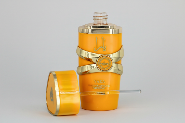 Orange and gold perfume bottle with decorative elements on a light gray background