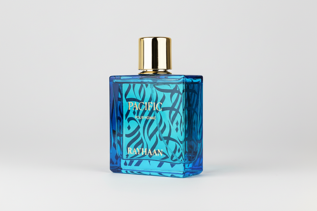 Blue perfume bottle with gold cap labeled 'Pacific' by Rayhaan on a white background