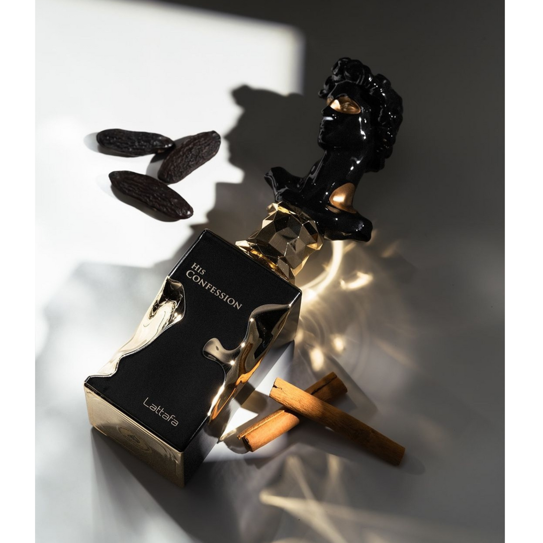 Lattafa His Confession EDP 100ml perfume bottle lying with tonka beans – rich long lasting woody aromatic scent with bergamot pink pepper, lavender sage cardamom, tonka bean cedarwood amber vetiver