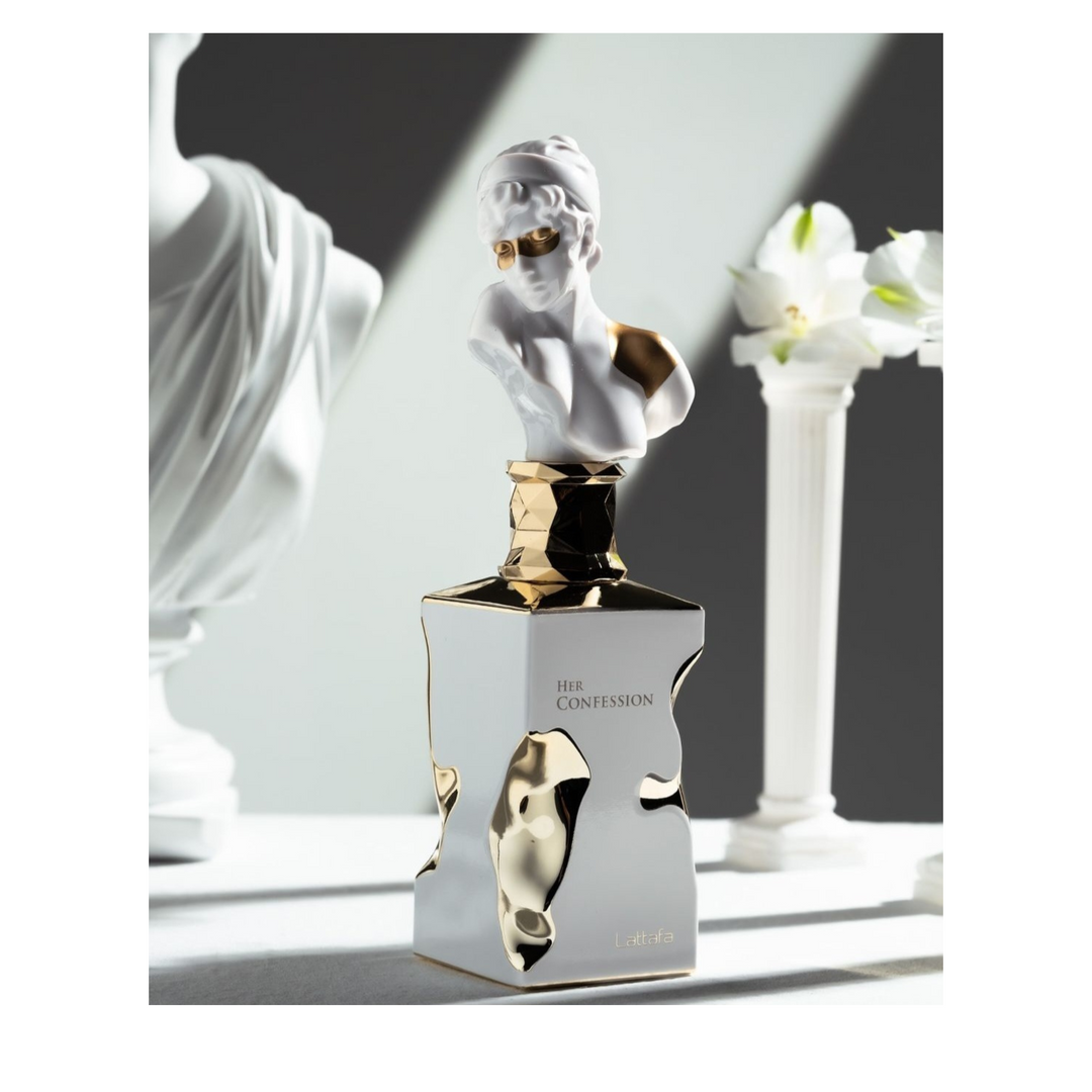 Lattafa Her Confession EDP 100ml perfume bottle straight front view on background with statues and column – sophisticated floral fruity scent with peach pink pepper bergamot, jasmine peony rose, vanilla musk sandalwood amber