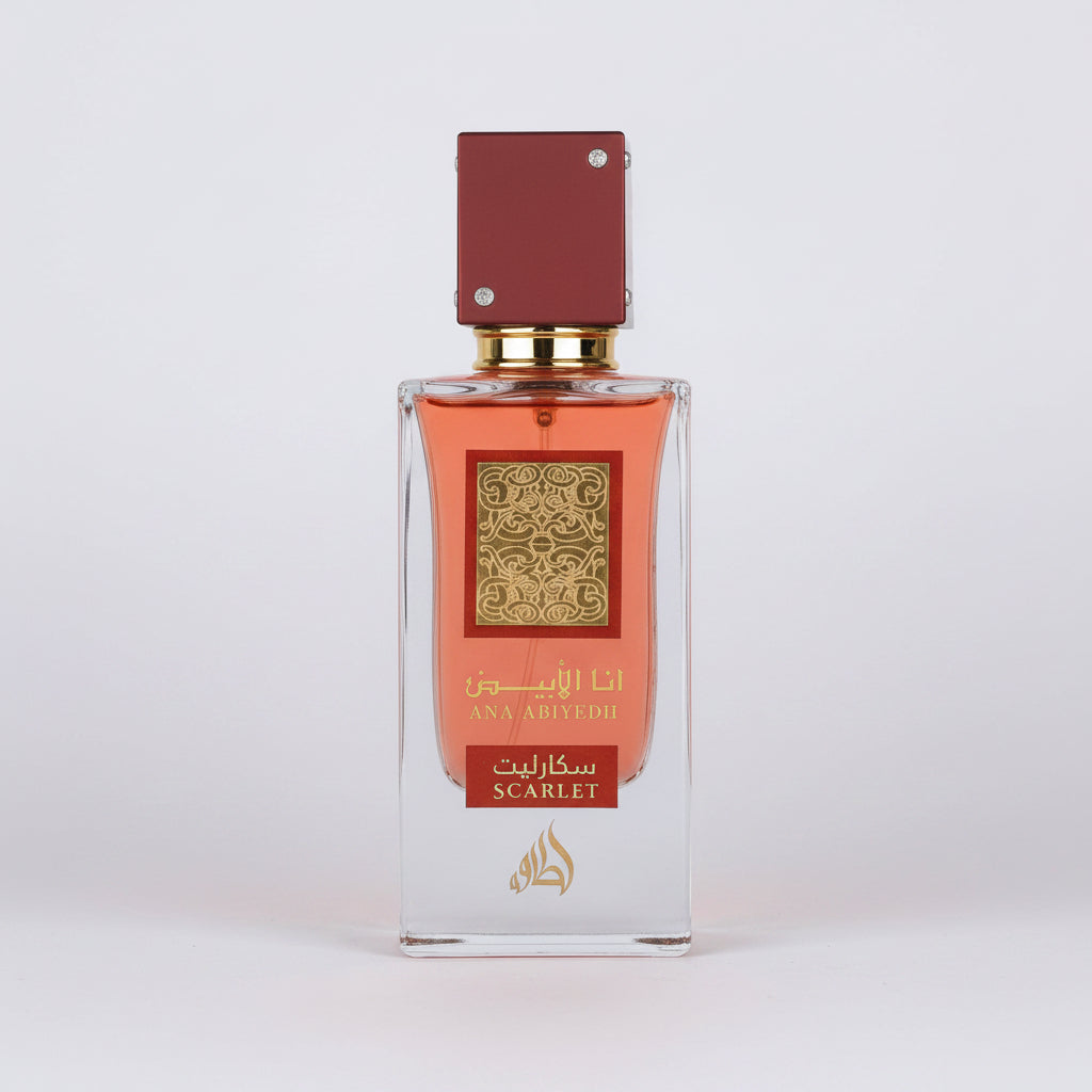 A rectangular glass perfume bottle with amber-orange liquid, a gold patterned label, and a dark red cap, shown on a plain white background. The label includes Arabic text and the word 'SCARLET'.