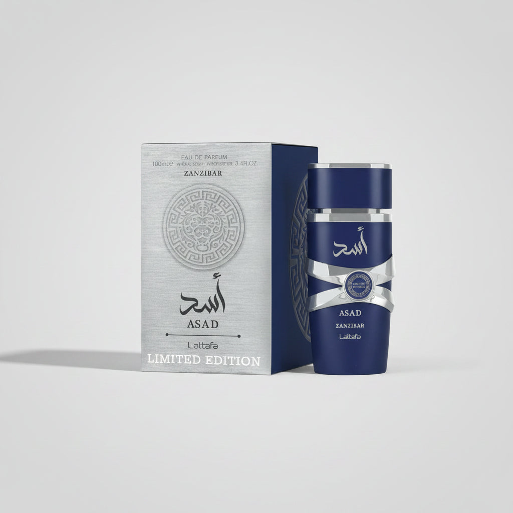 Blue perfume bottle with silver cap and 'Asad' branding next to its packaging on a white background