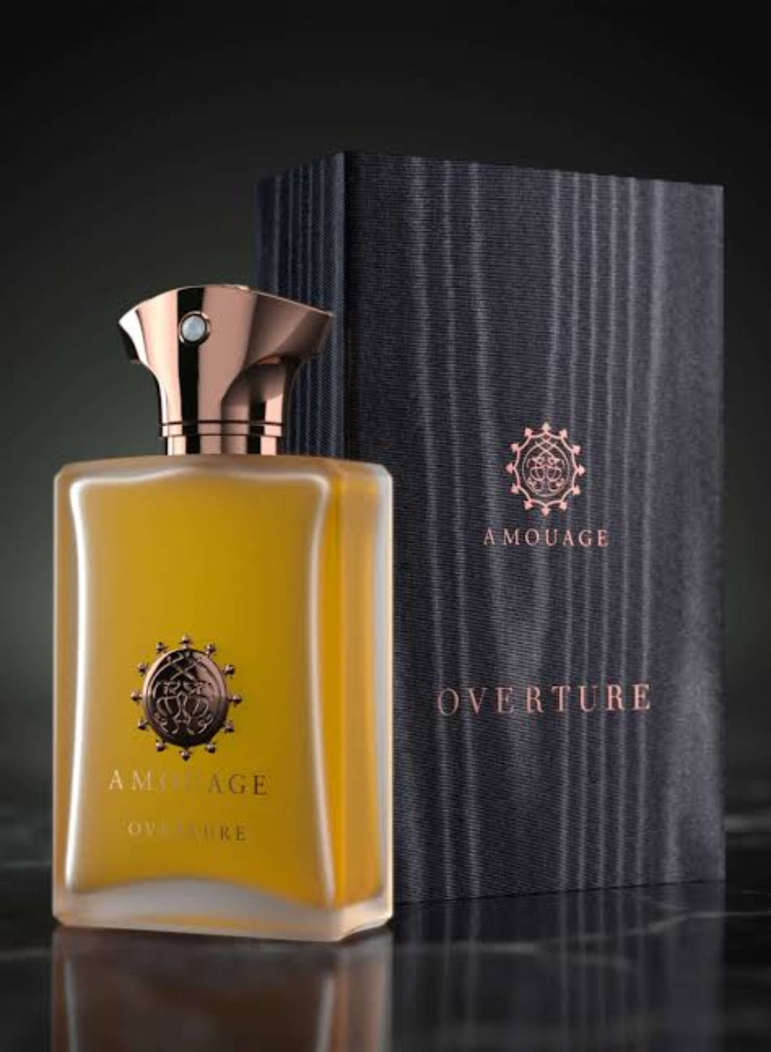 Amouage Overture perfume bottle and packaging on a dark background