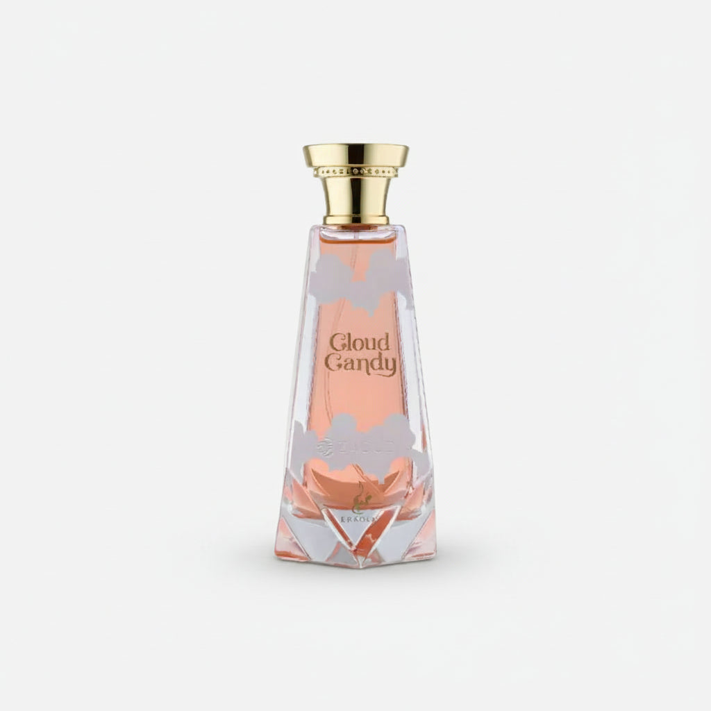 A faceted glass perfume bottle filled with pink liquid, featuring a gold cap and the text 'Cloud Candy' on the front, set against a plain white background.
