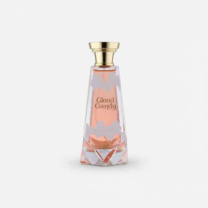 A faceted glass perfume bottle filled with pink liquid, featuring a gold cap and the text 'Cloud Candy' on the front, set against a plain white background.