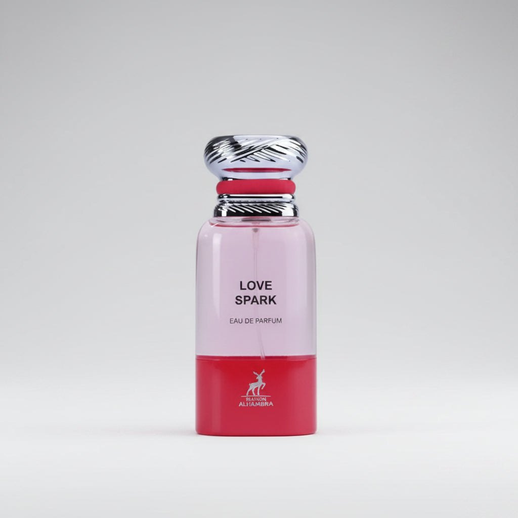 A perfume bottle labeled 'LOVE SPARK' with a pink upper half, red lower half, and a silver cap, set against a light gray background.