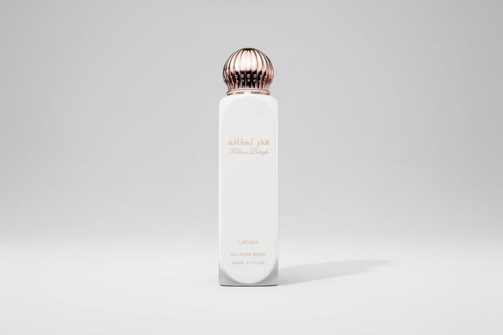 White perfume bottle with a gold cap on a white background