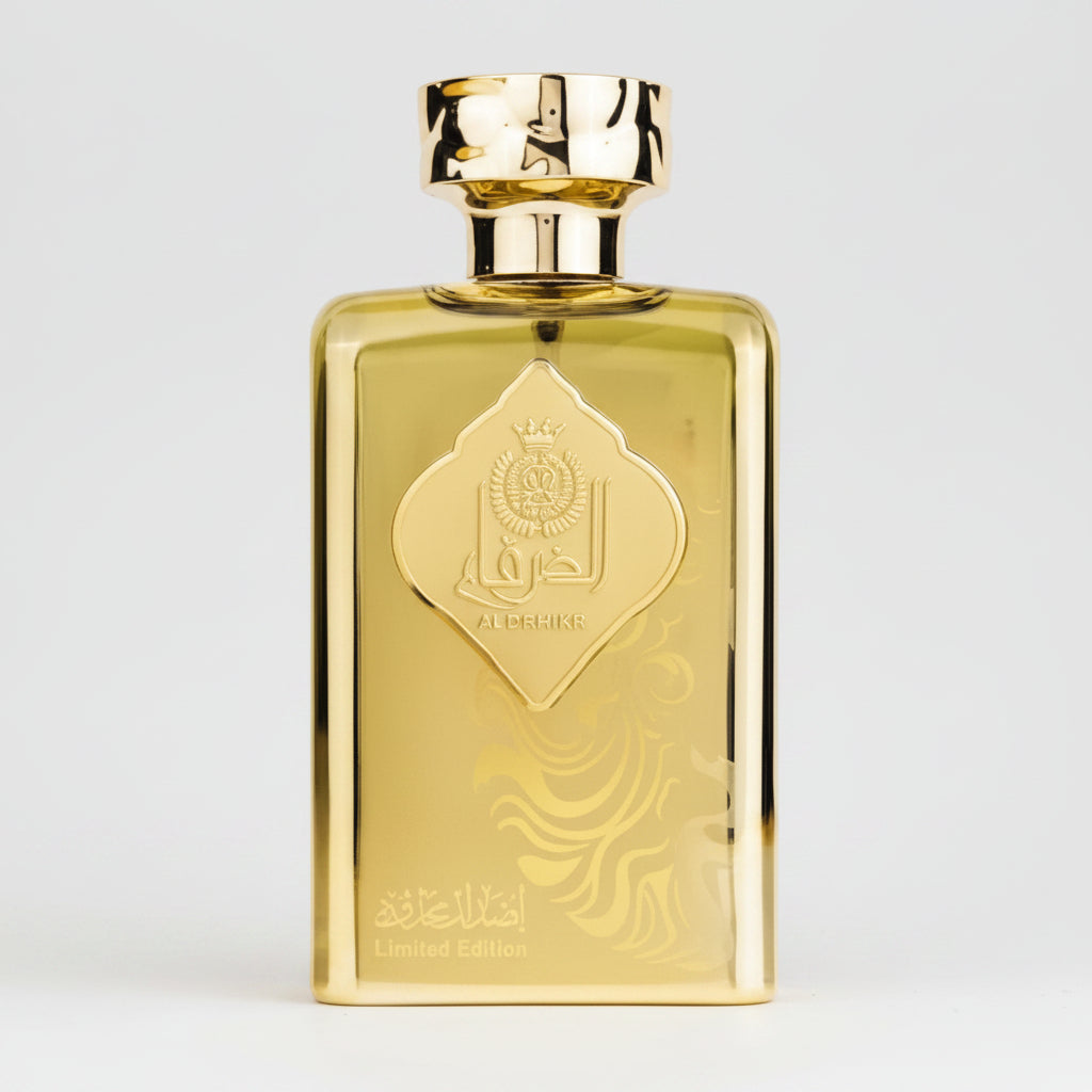 A rectangular gold perfume bottle with a matching gold cap, featuring an embossed diamond-shaped emblem on the front, set against a plain white background.